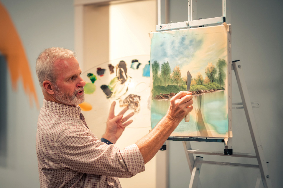 Man painting at Minnetrista Museum & Gardens’ Bob Ross Experience in Muncie, Indiana (photo courtesy of the Bob Ross Experience) Man painting at Minnetrista Museum & Gardens’ Bob Ross Experience in Muncie, Indiana (photo courtesy of the Bob Ross Experience)